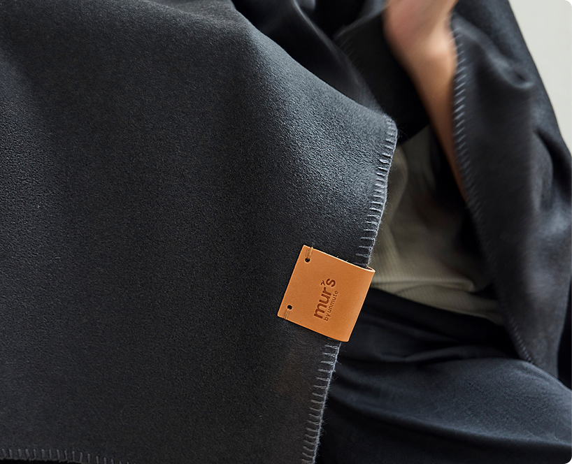 Close-up of a Murmurs throw with its leather label
